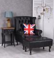 czarny fotel uszak z podnóżkiem styl chesterfield